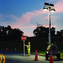 Traffic control professional being properly lit by floodlight tower