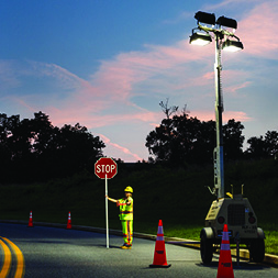 Traffic control professional being properly lit by floodlight tower