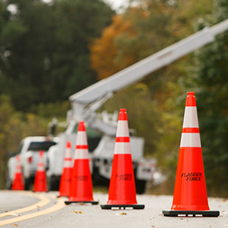 Infrastructure update: bucket truck in work zone—closeup of cones.
