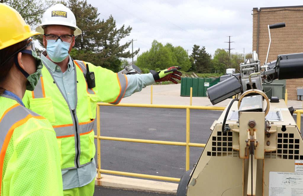 Justin Zellers training an employee on how to use a light tower.