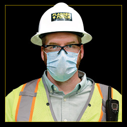 Justin Zellers headshot—wearing his PPE and a mask