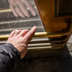 Hand on metal door handle