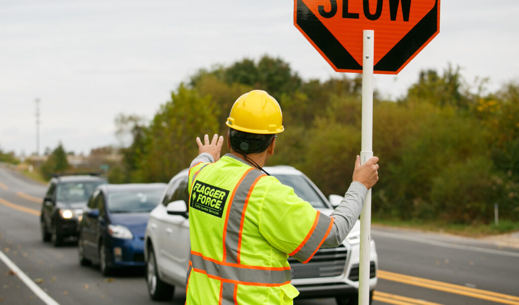 Flagger Force employee stops vehicle in work zone