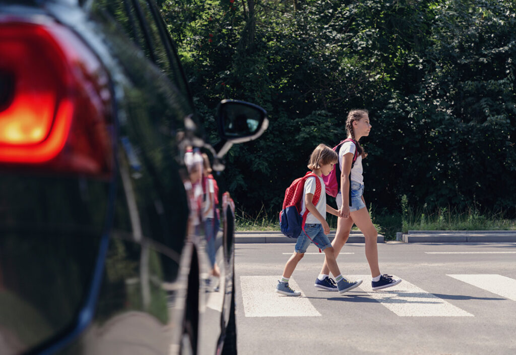 Pedestrian Children Crossing Crosswalk with Car in Foreground