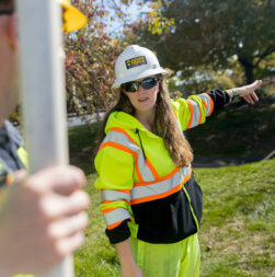 Woman in PPE in work zone talking to flagger