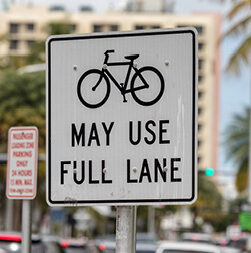 road sign: bikes may use full lane